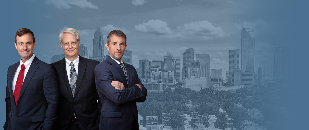 Photo of the Attorneys over a Charlotte, North Carolina's skyline