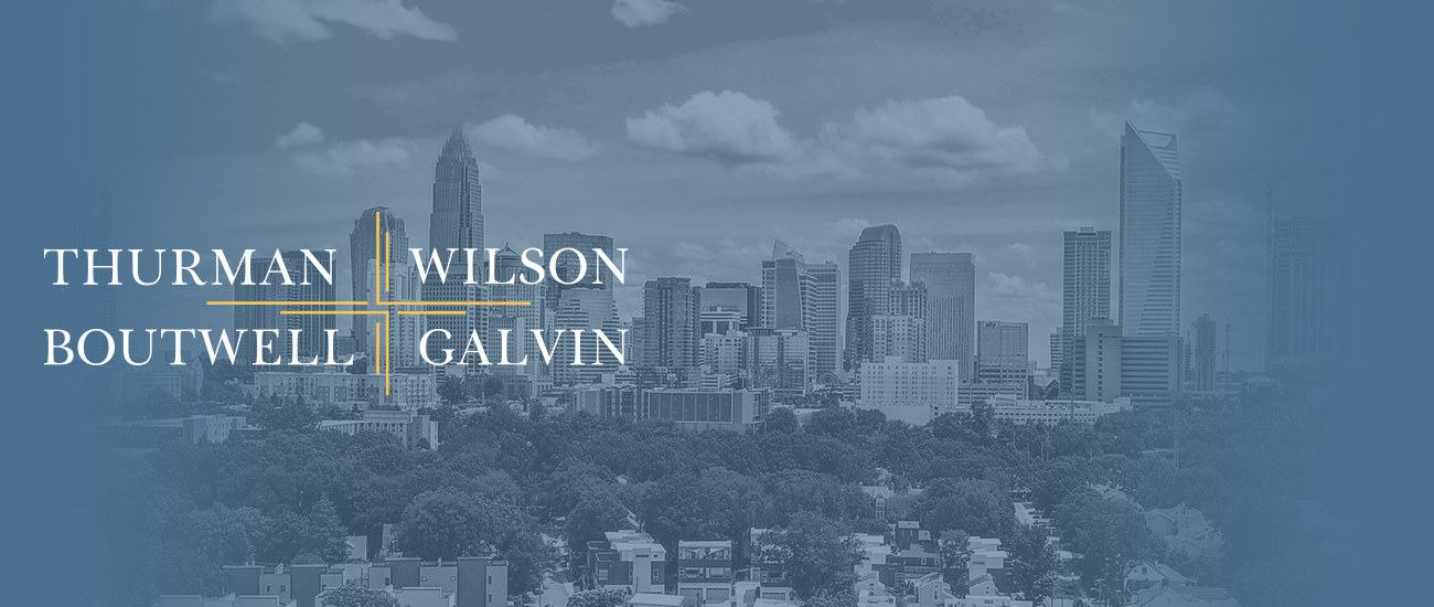 Logo of Thurman, Wilson, Boutwell & Galvin P.A. over a Charlotte, North Carolina's skyline